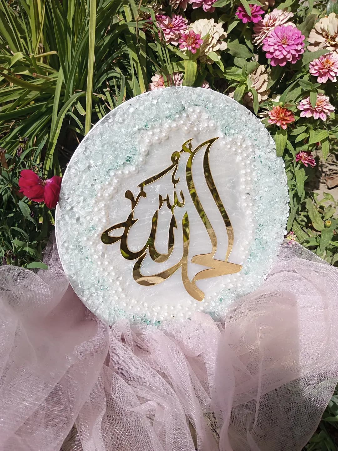 Islamic cardboard is made on a round tablet made of small stones with the inscription Allah