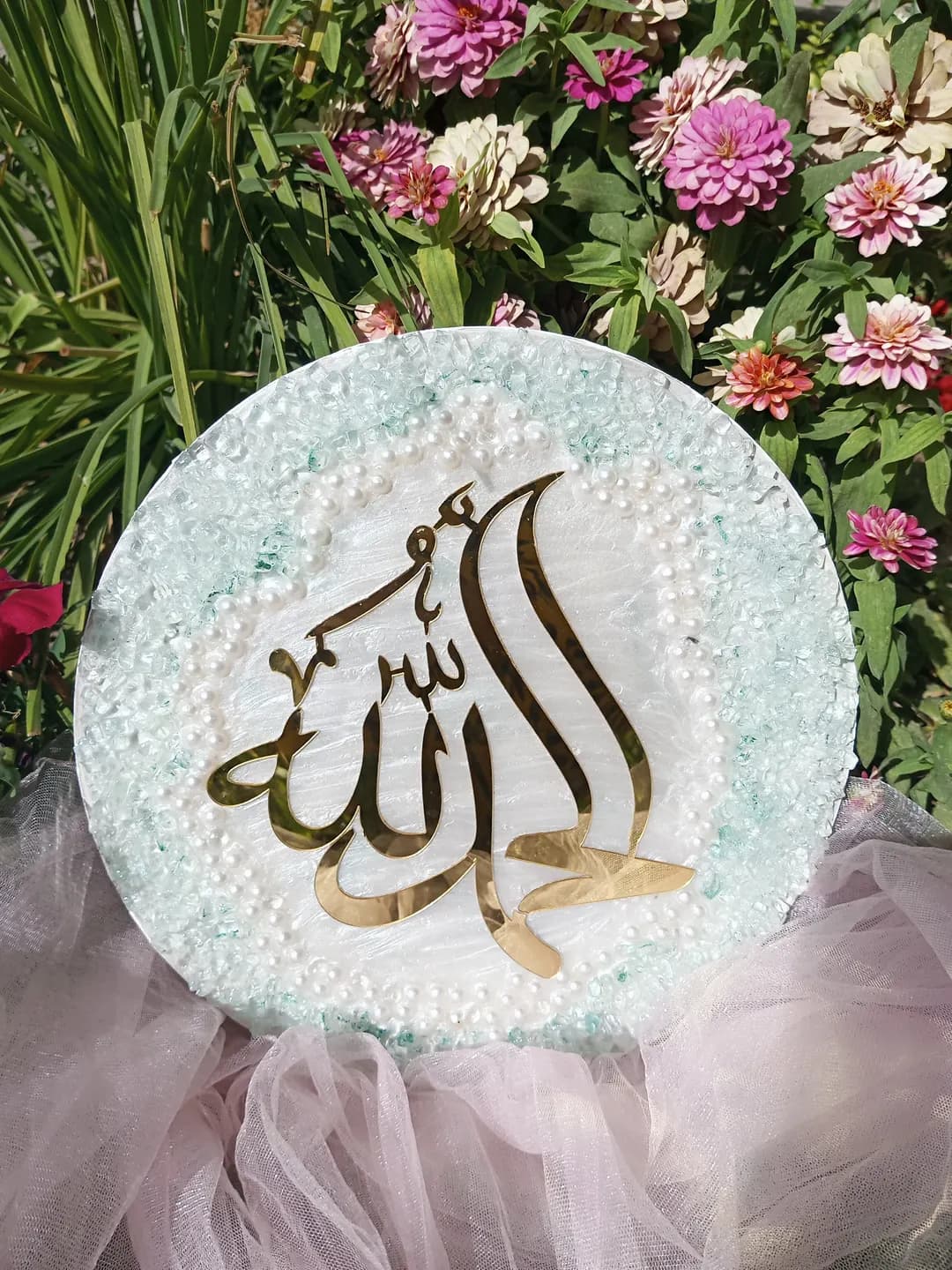 Islamic cardboard is made on a round tablet made of small stones with the inscription Allah