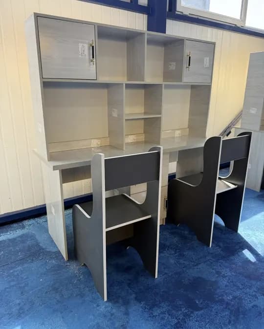 A modern study desk for two people is for sale.